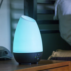 Aromatherapy diffuser cycling seven LED colors for ambient mood lighting.
