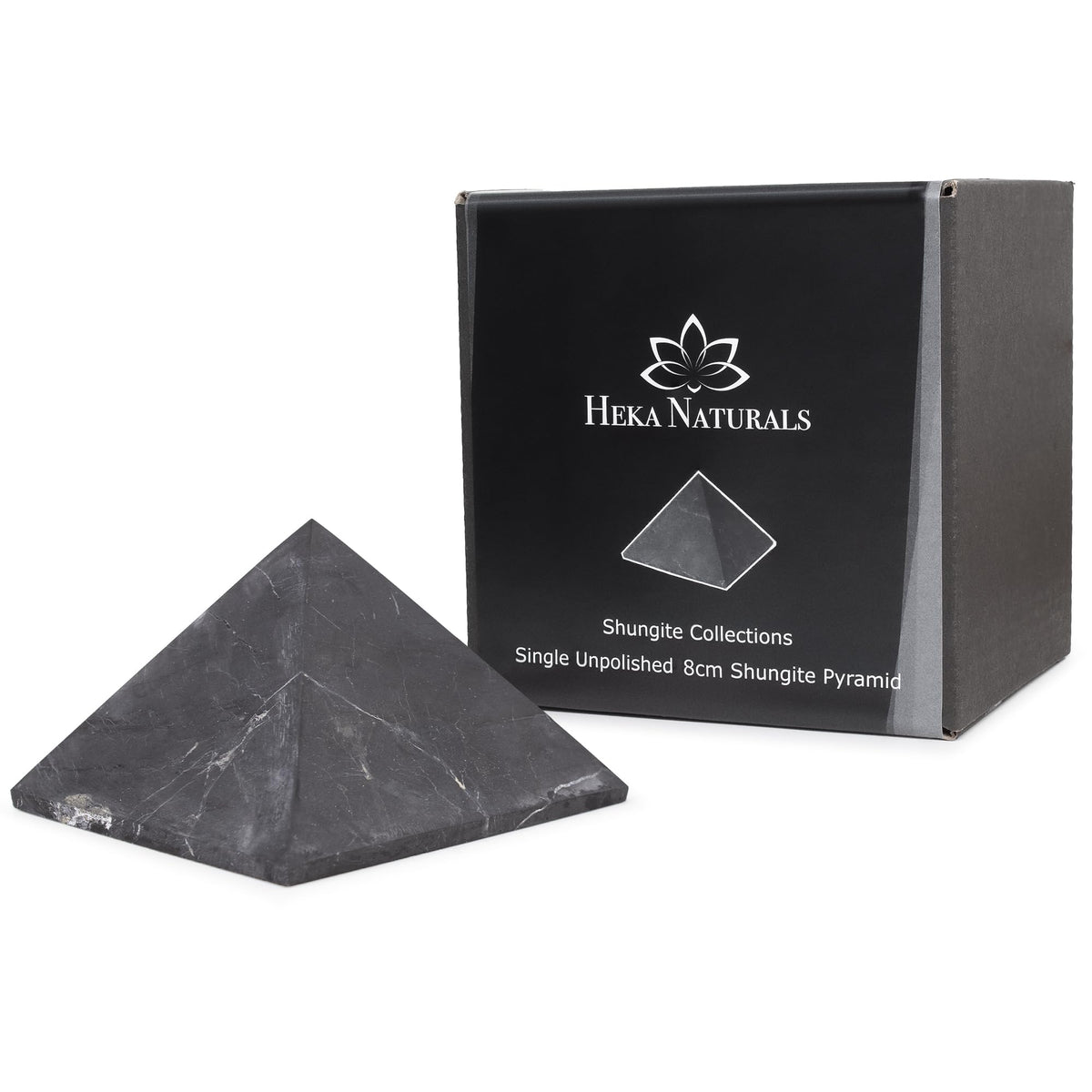 Heka Naturals unpolished shungite pyramid on desk for a calming focal point
