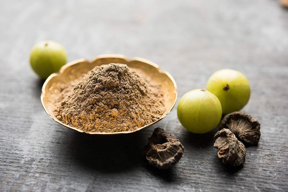 Hemani Amla powder bottle label highlights vegan and non-GMO