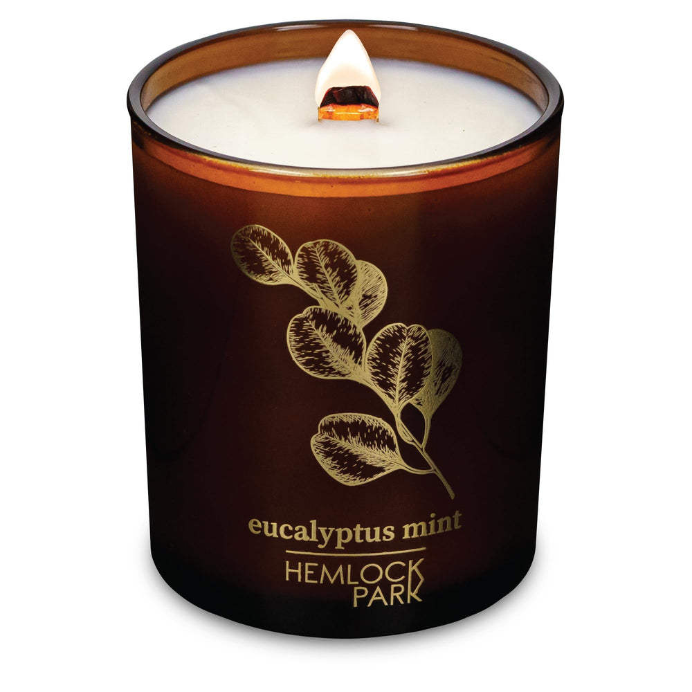 Hemlock Park Amber & Gold wood wick candle with a steady flame for cozy evenings.