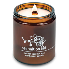 Hemlock Park crackling wick candle in amber jar creates cozy ambiance.