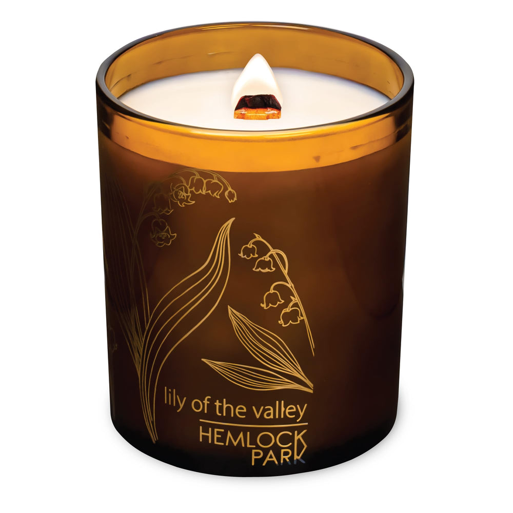 Hemlock Park wooden wick candle close-up showing warm glow and natural coconut wax