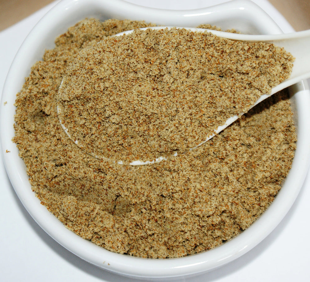 Herba Organica Milk Thistle Seeds Powder dispenser with a scoop illustrating versatile use in smoothies