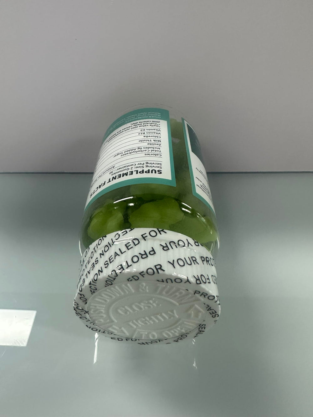 Ingredient close-up highlights chlorella present for natural elimination support.