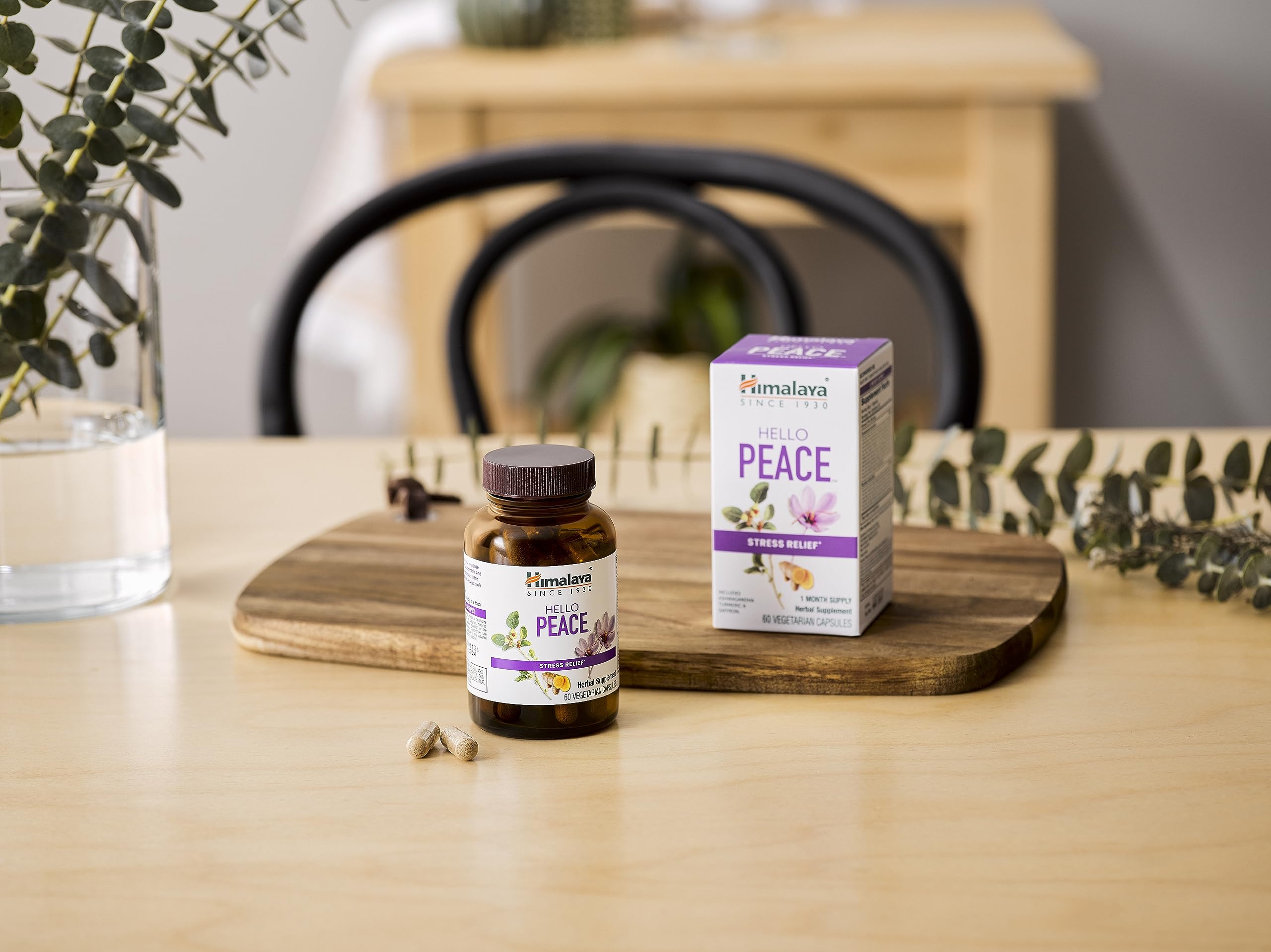 Himalaya Hello Peace bottle with herbs around conveys Ayurvedic relief concept.