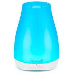 Homeweeks diffuser compact on a nightstand with soft ambient light and calm mist.