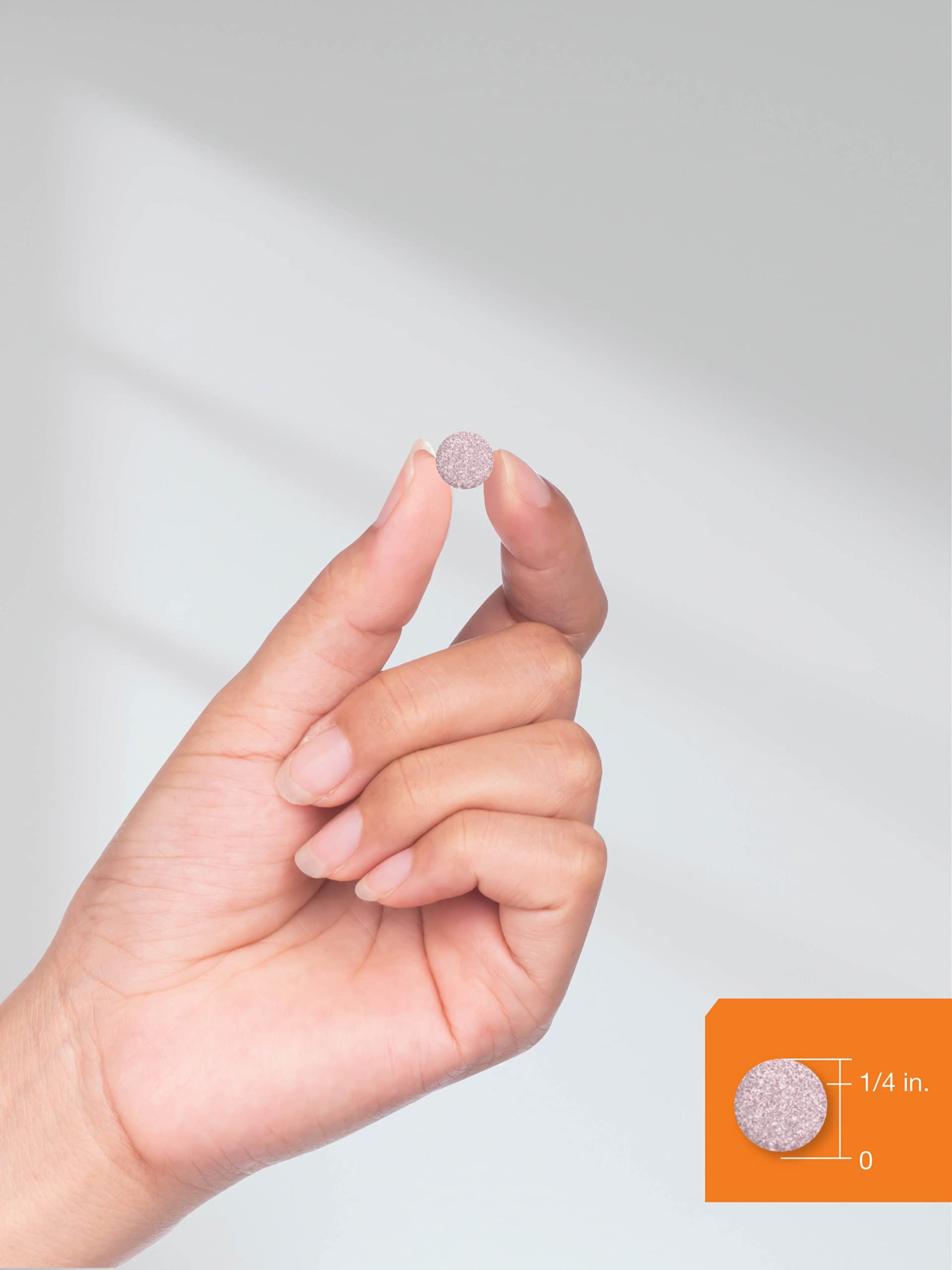 Lifestyle shot of a person taking Horbäach B12 berry tablet