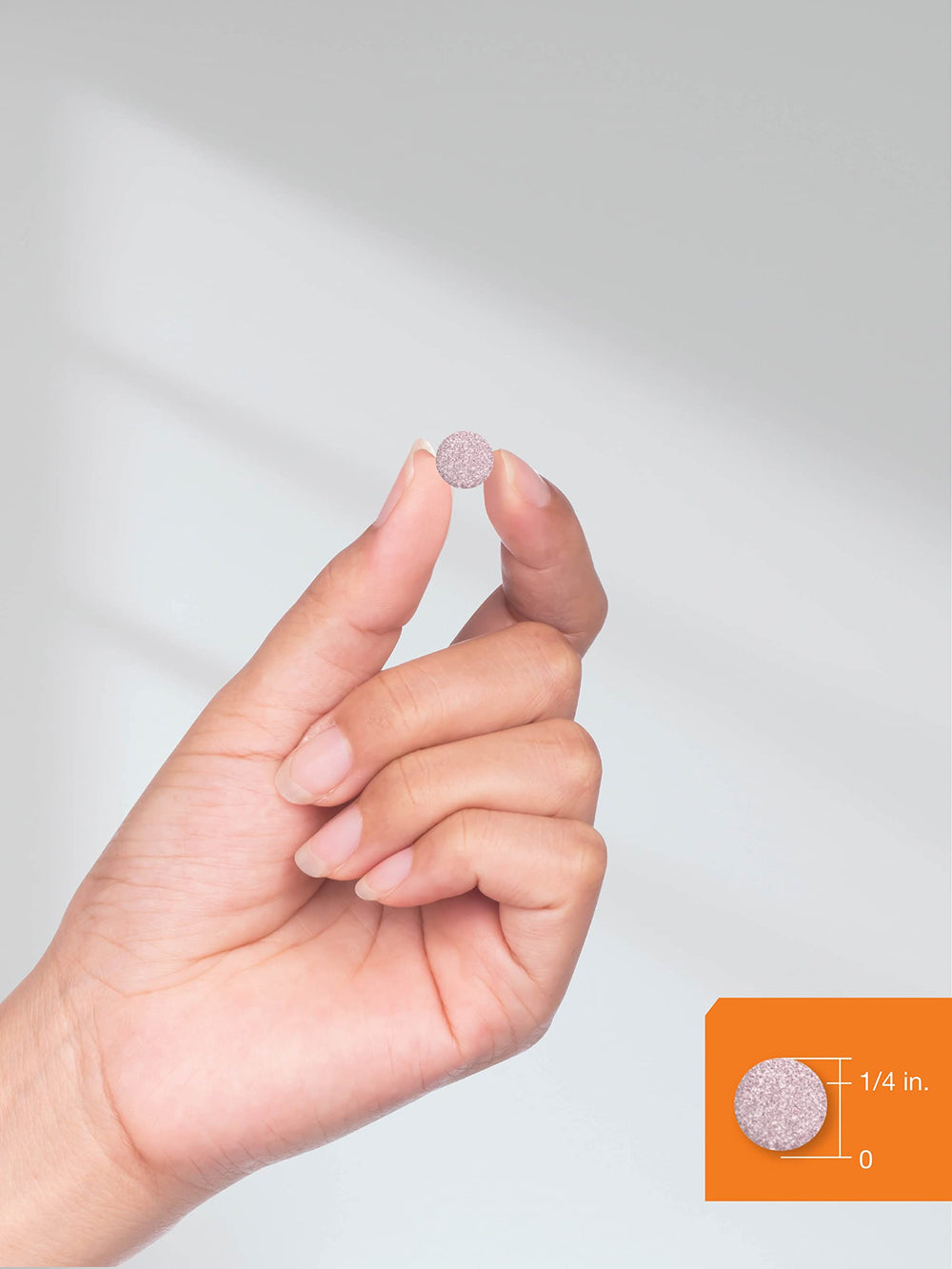 Lifestyle shot of a person taking Horbäach B12 berry tablet