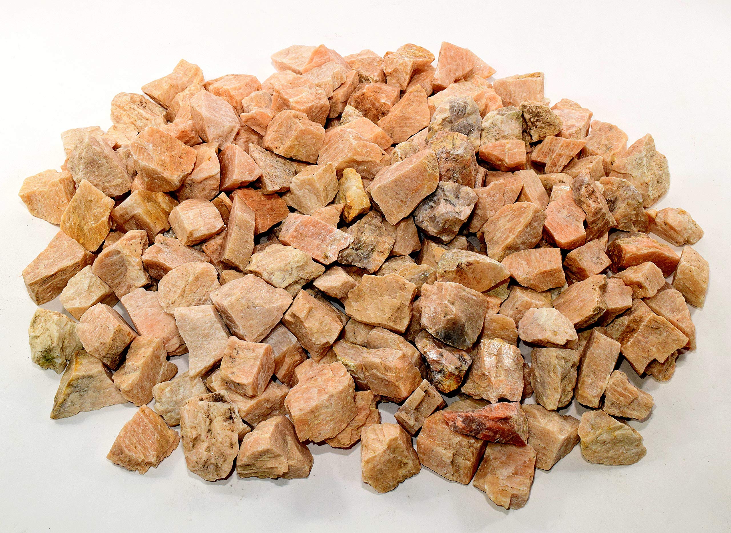 HQRP Peach Moonstone rough stones held in hand for scale and texture