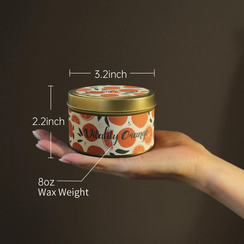 HUAN XI orange scented candle lit, evoking a cozy atmosphere.
