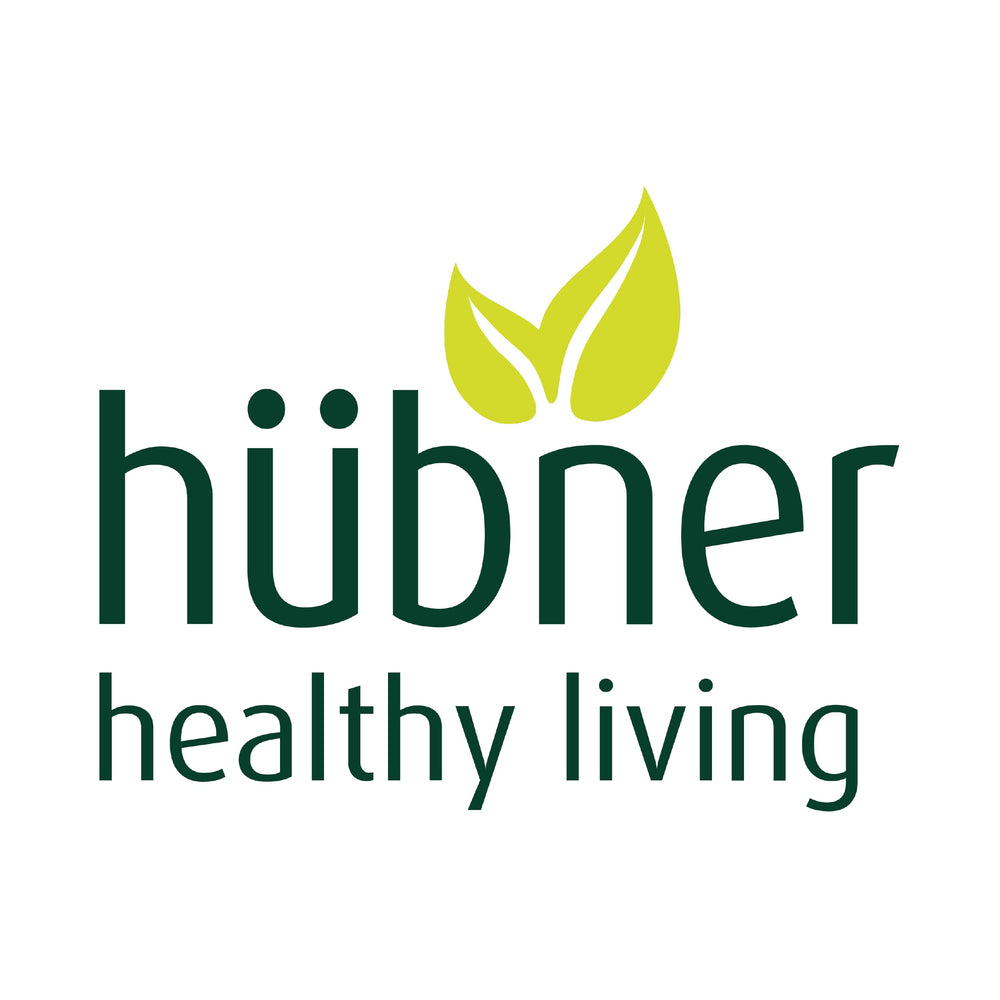 Glass-dispensing visual of Hübner Iron Vital bottle for tidy dosing.