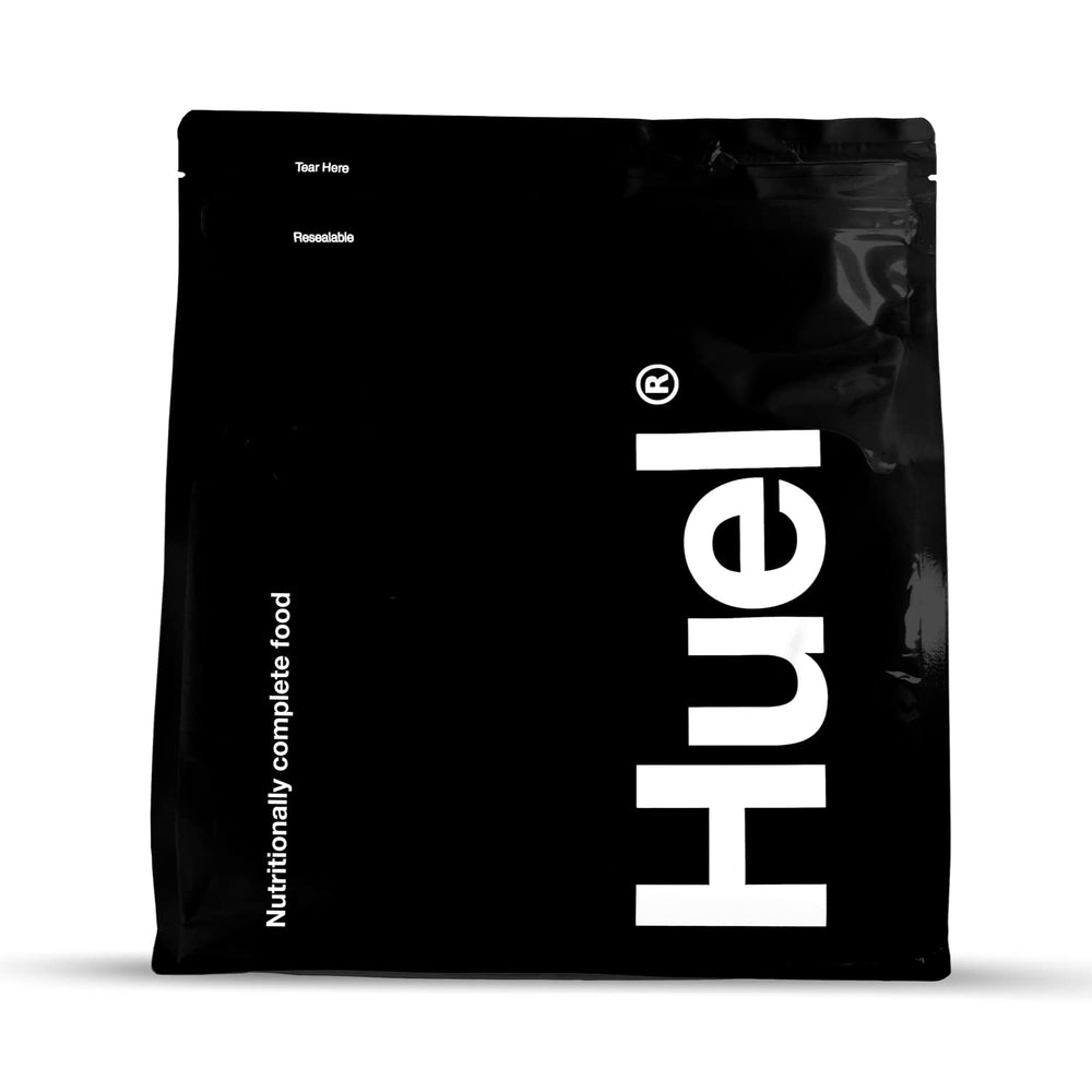 Huel Black Vanilla bottle pouring for a quick meal on the go.