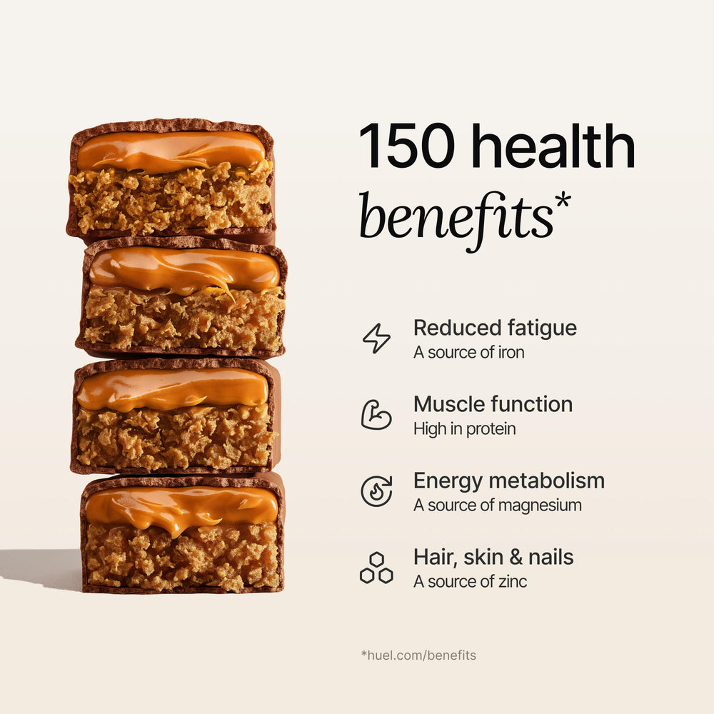 Huel Complete Nutrition Bar at desk in office setting for convenient snacking.
