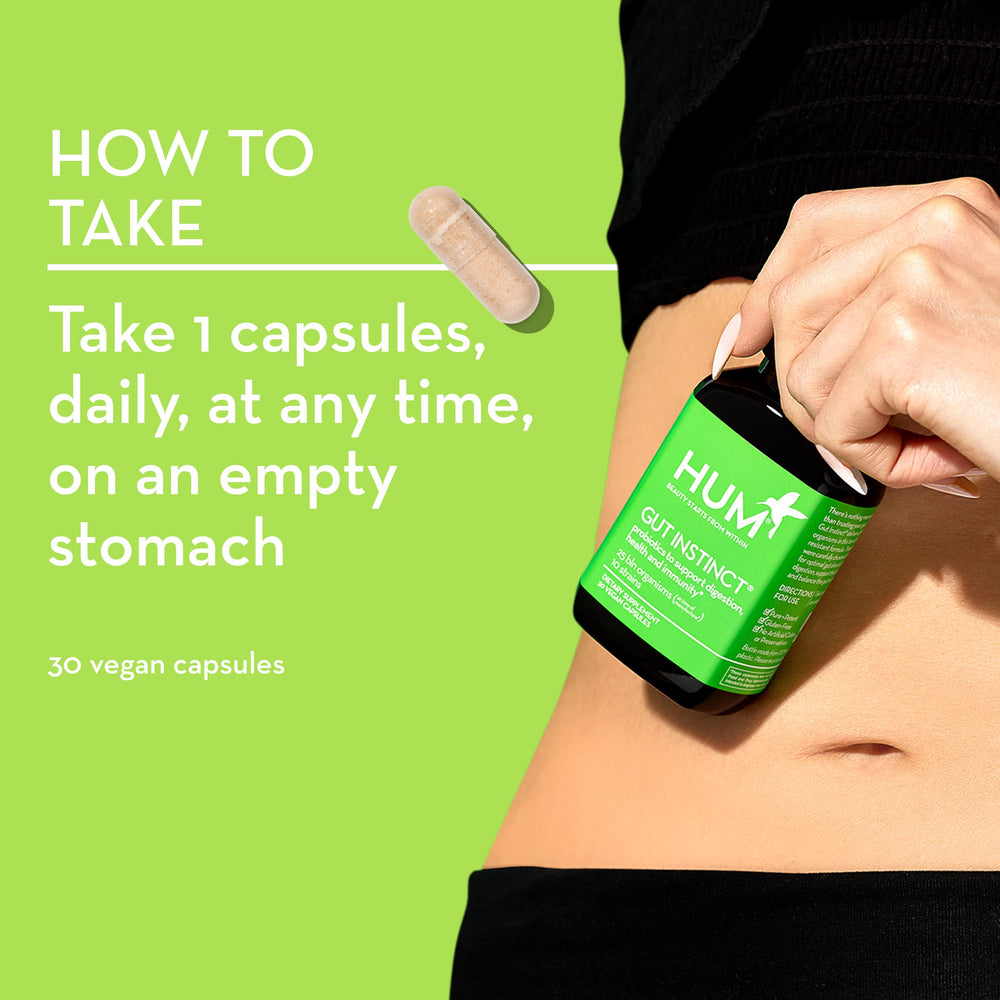 Person taking a HUM Gut Instinct capsule as part of a daily routine