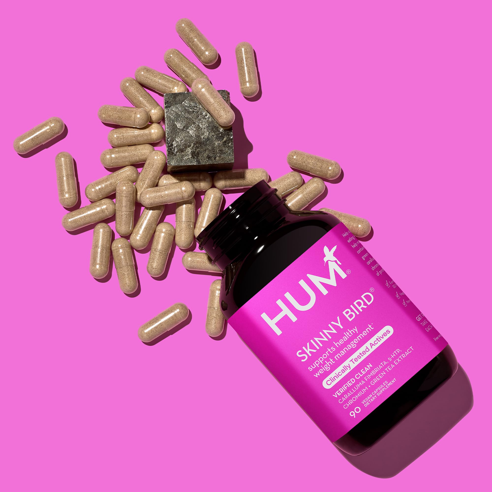 HUM Skinny Bird capsules in hand emphasize convenient daily use.