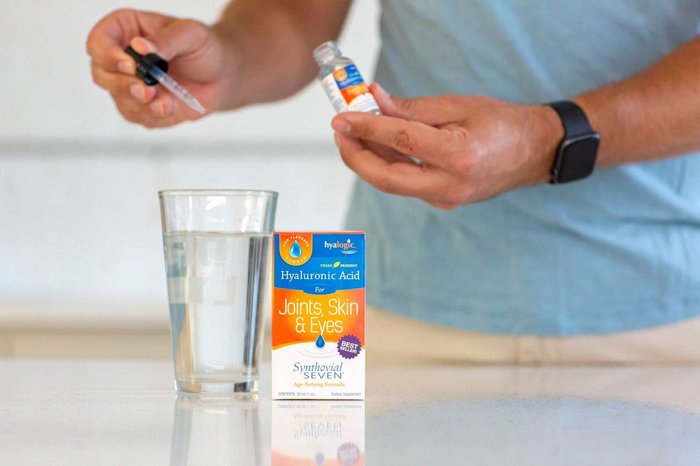 Hyalogic Synthovial Seven hands holding bottle ready to take.