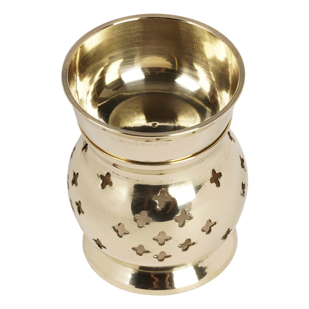 IBA Indianbeautifulart brass oil burner lit, adding soft light and scent to living spaces.