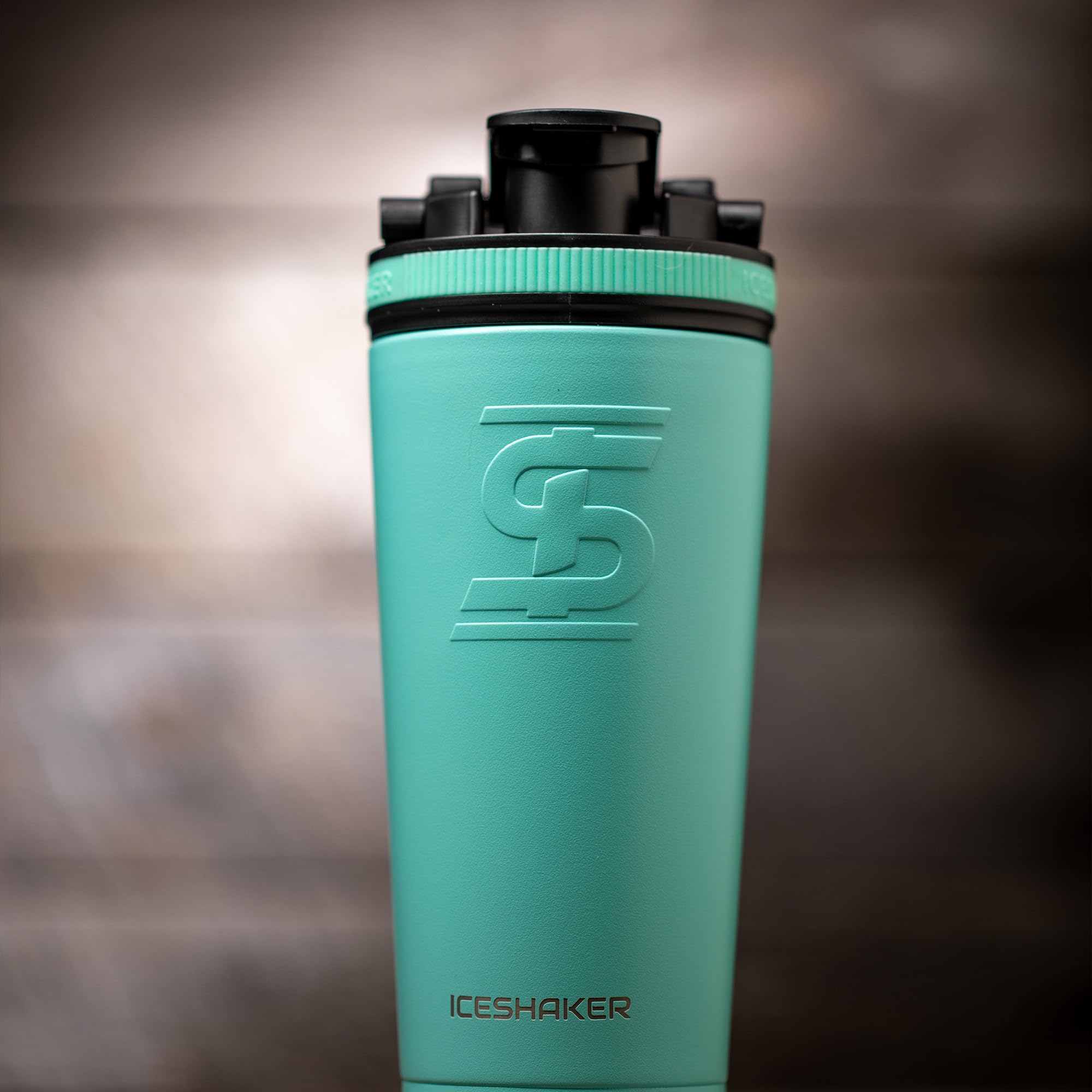 Ice Shaker 26oz mint bottle in a cup holder for easy transport.