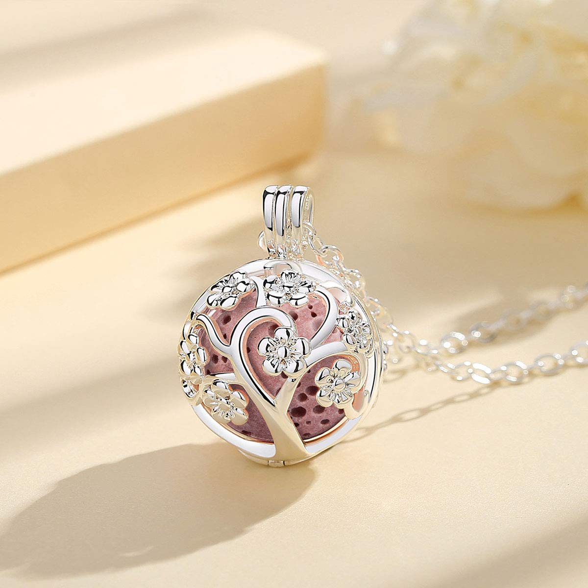 INFUSEU Sakura Tree aroma locket open showing diffuser-ready interior for essential oils.
