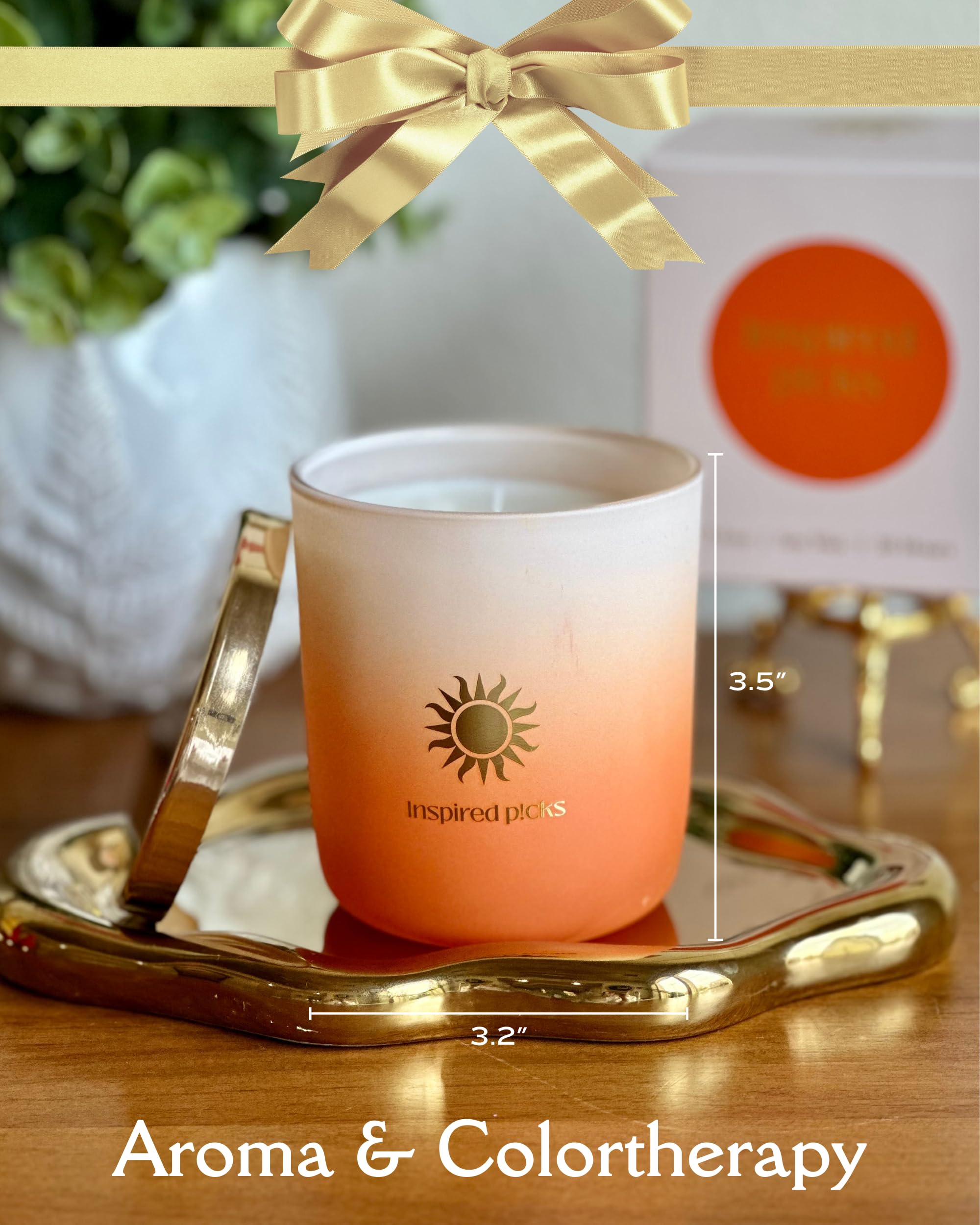 Inspired Picks Orange Candle with gold sun symbol lid enhances luxury decor.