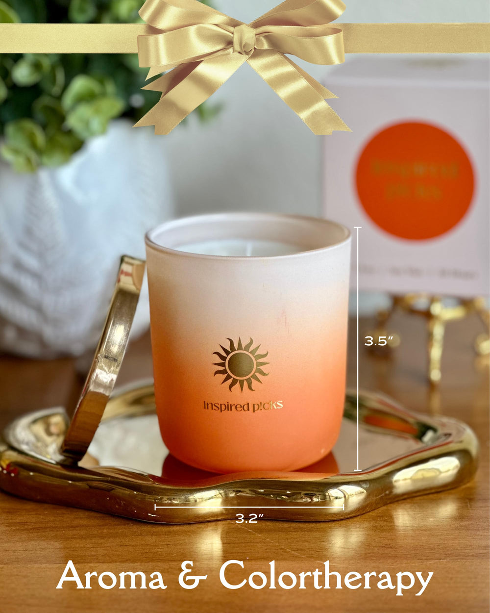 Inspired Picks Orange Candle with gold sun symbol lid enhances luxury decor.