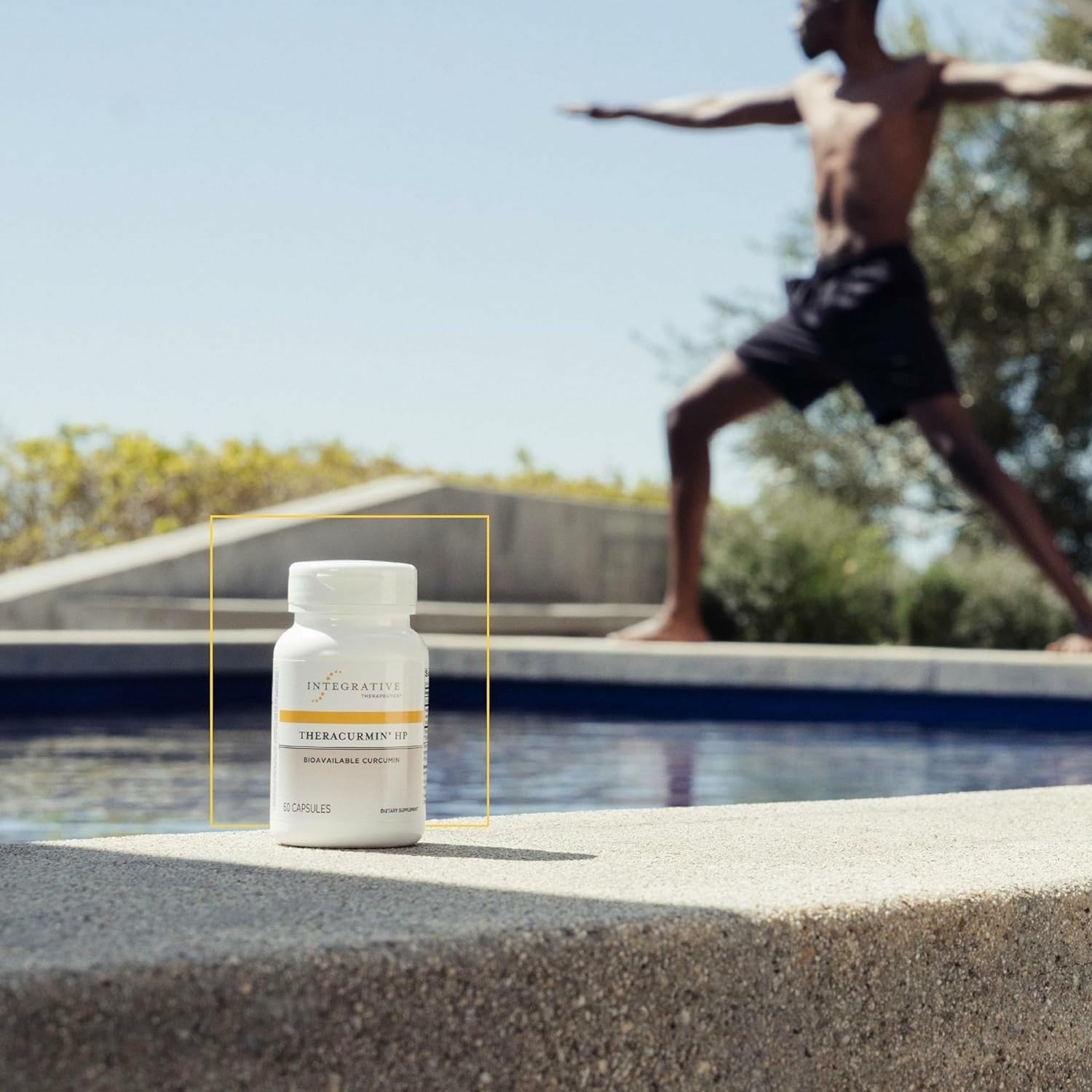 Integrative Therapeutics Theracurmin HP bottle with glass of water implying easy swallowing.