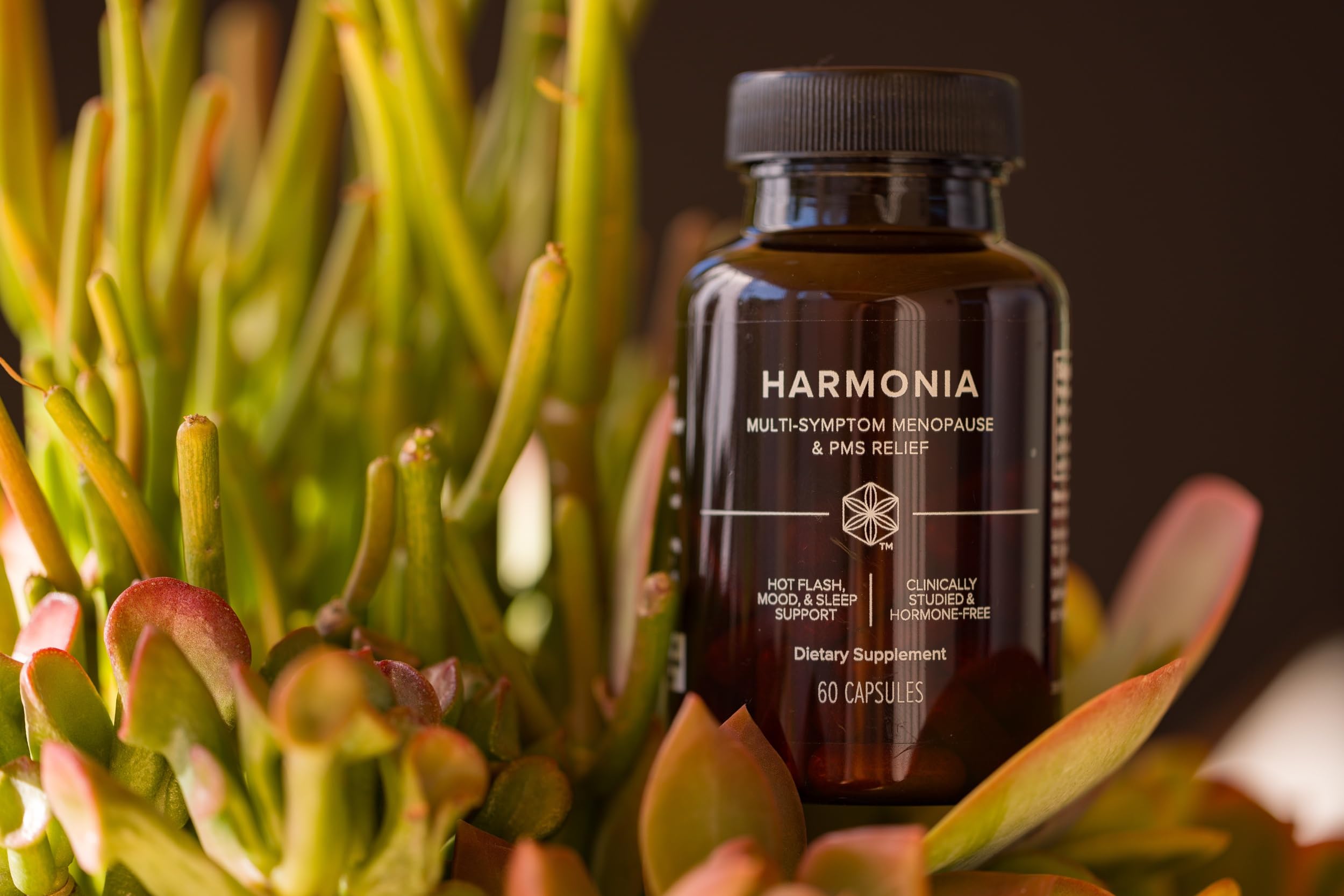 Isagenix Harmonia GMP-certified facility seal alongside bottle.