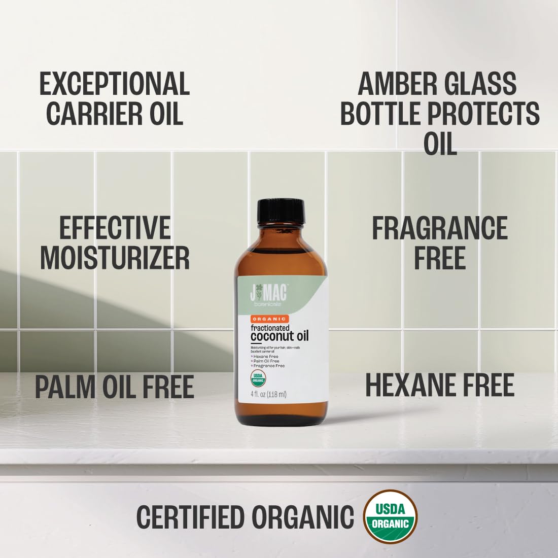 J MAC BOTANICALS glass bottle packaging emphasizing 100% coconut-derived MCT oil for skin and hair.