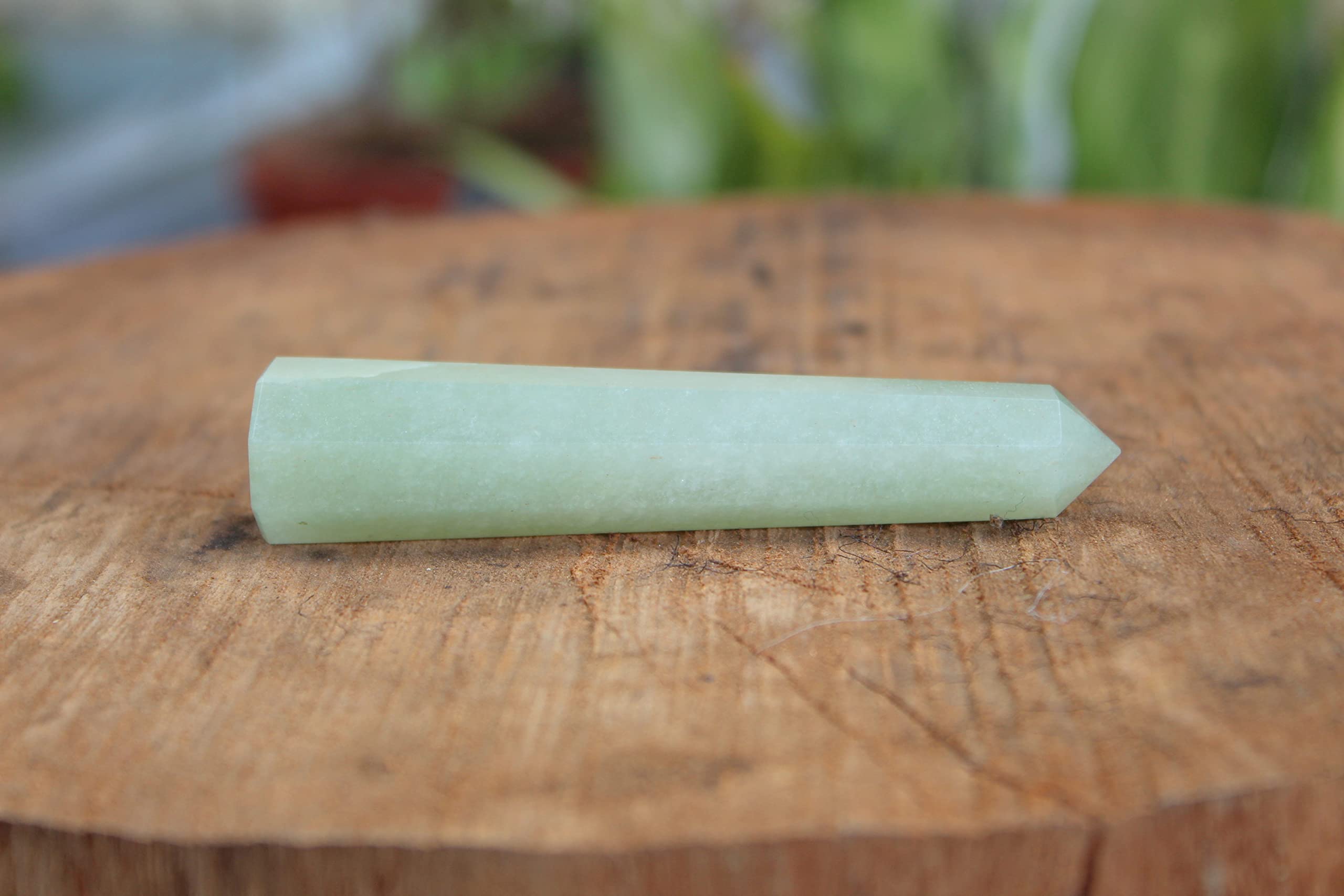 Jet International green aventurine obelisk in meditation space supports focused energy.