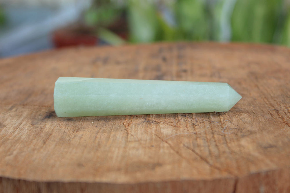 Jet International green aventurine obelisk in meditation space supports focused energy.