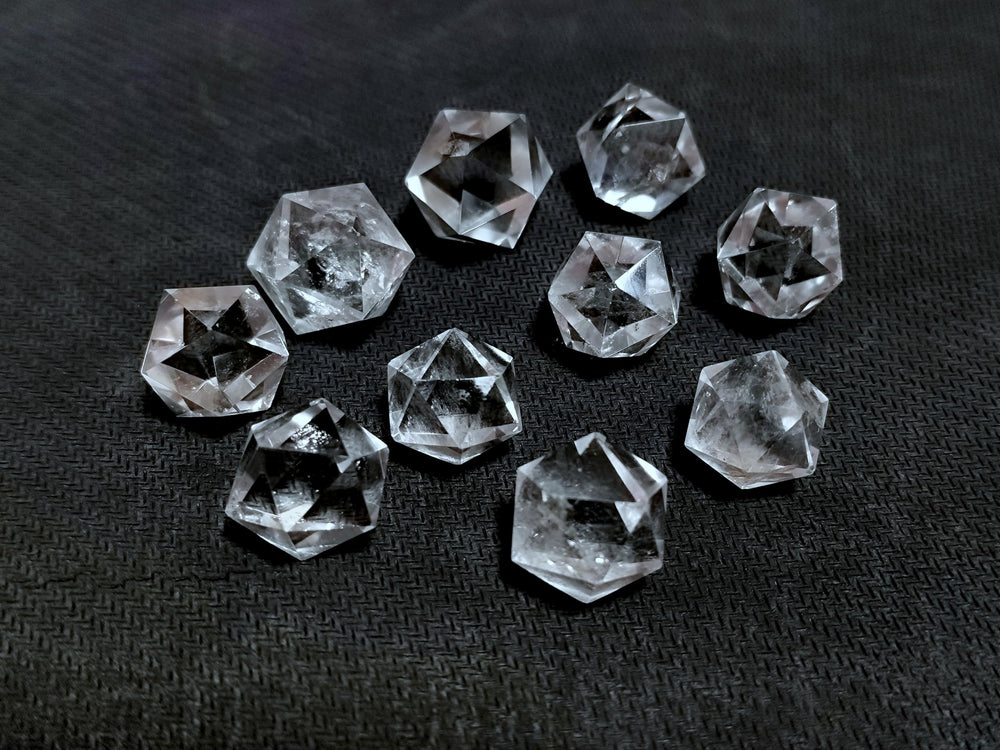 Jet International icosahedron pendant resting on an altar for focus.