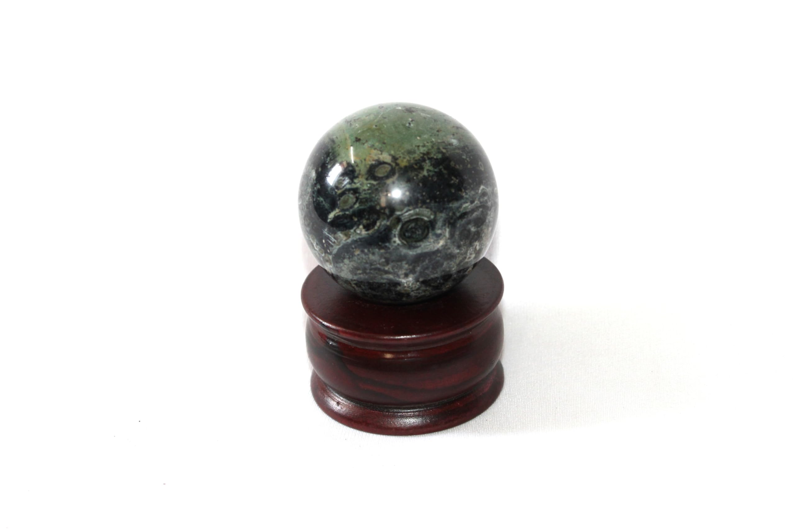 Jet International Kambaba Jasper sphere on an altar display supports mindful ritual.