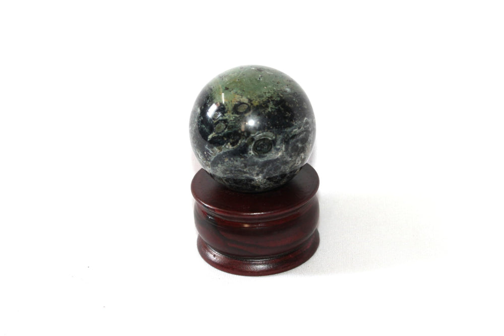 Jet International Kambaba Jasper sphere on an altar display supports mindful ritual.