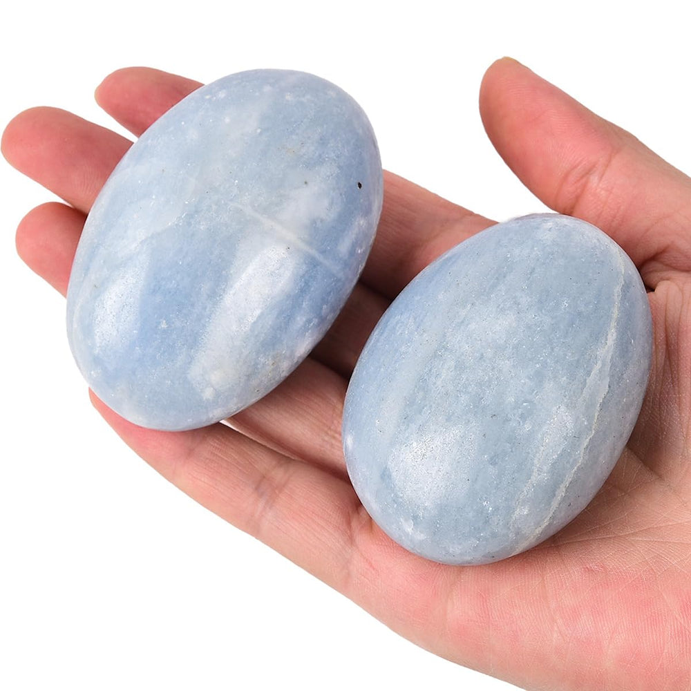 JIC Gem blue celestite palm stone held in hand for relaxation and balance.