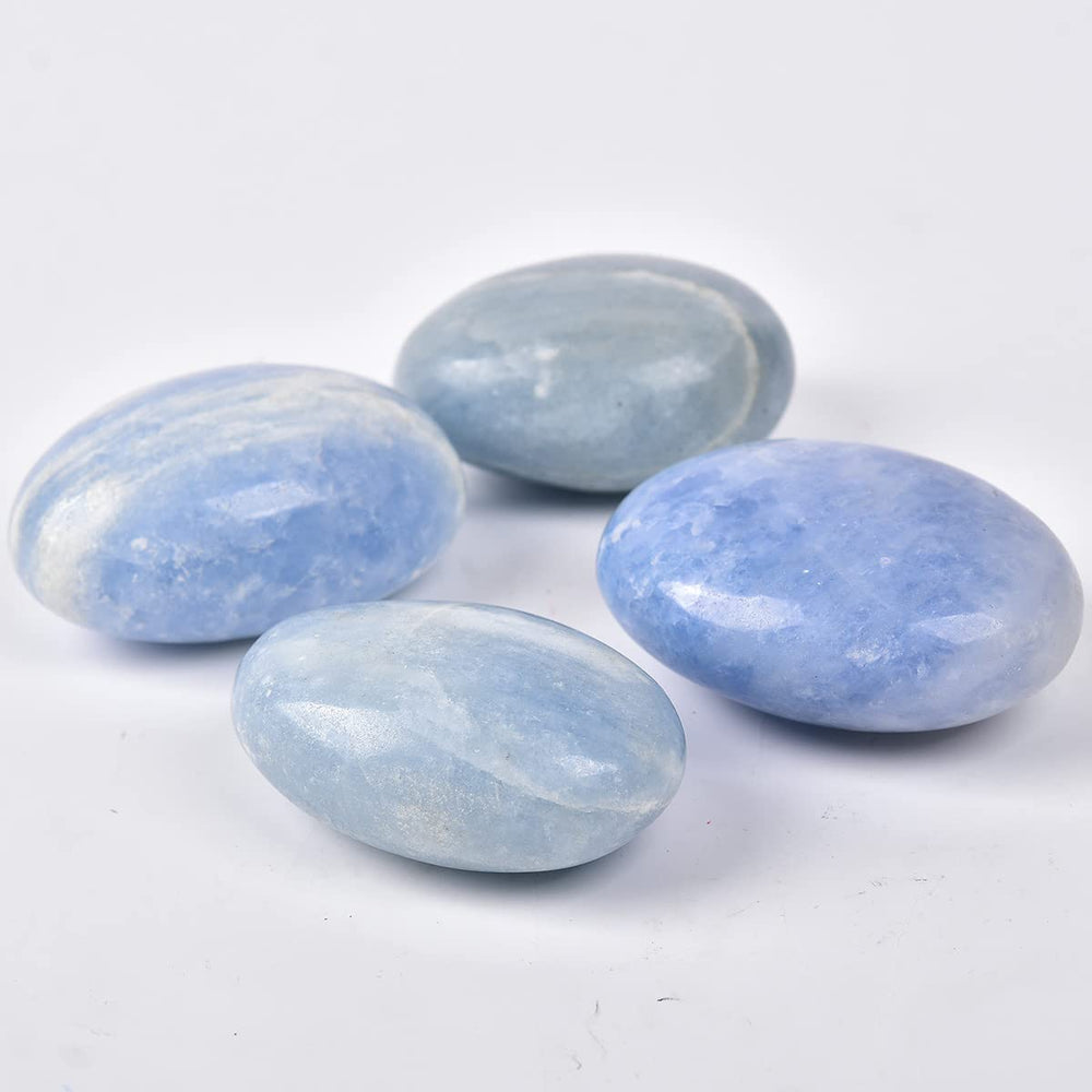 JIC Gem blue celestite palm stone on desk for mindful pauses.