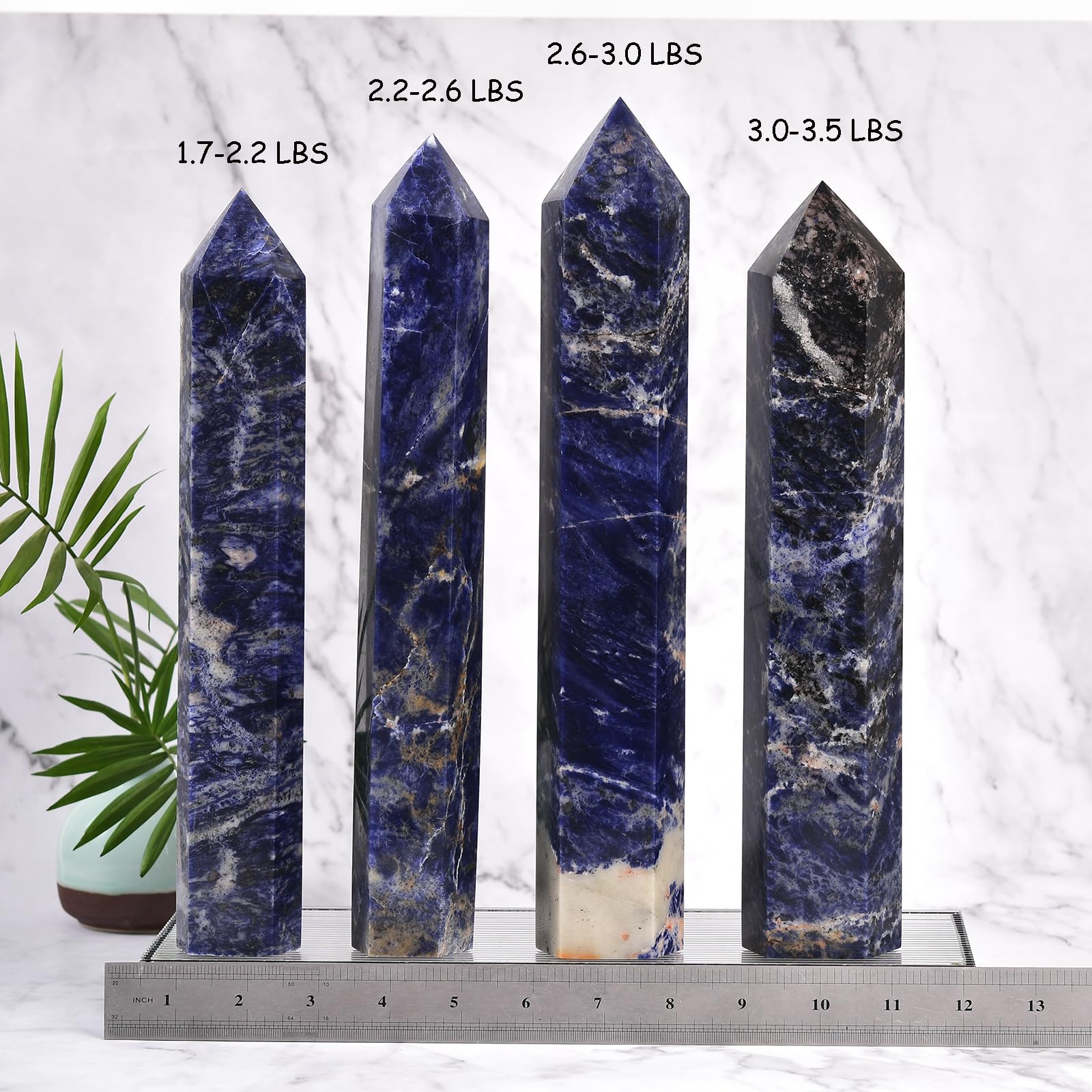 JIC Gem blue sodalite obelisk tower on wood desk showing natural variation.