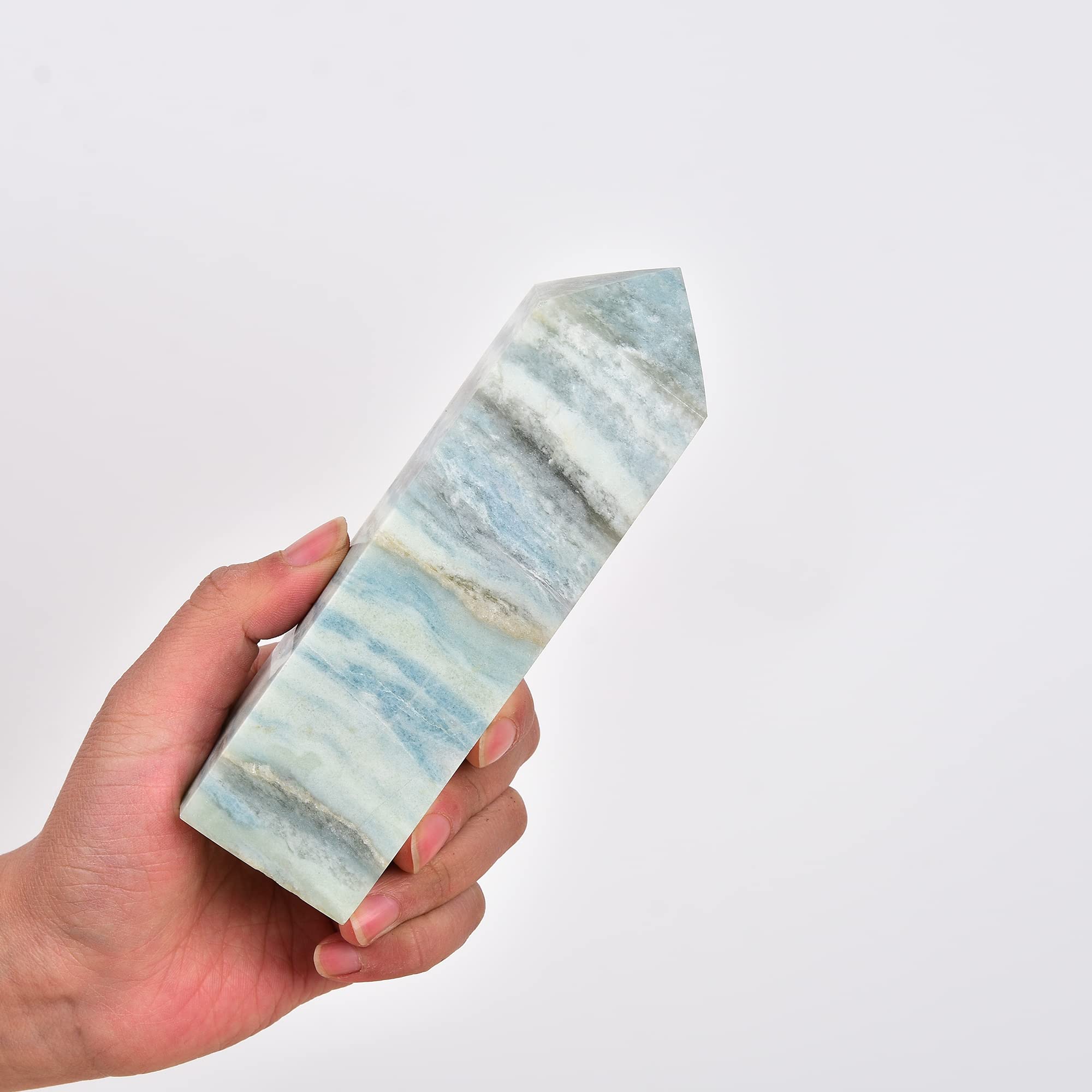Celestite wand and blue aura calcite tower showcased on a shelf setup