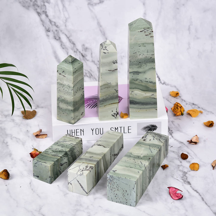 JIC Gem crystal obelisk chakra decor stands elegantly on a desk.