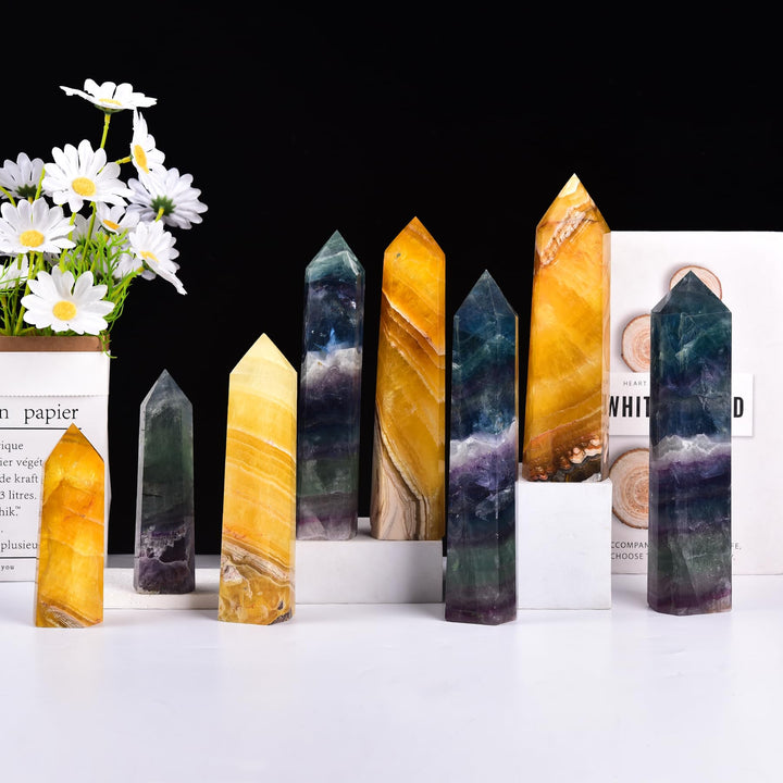 JIC Gem fluorite obelisk showcases radiant fluorescence in soft light.