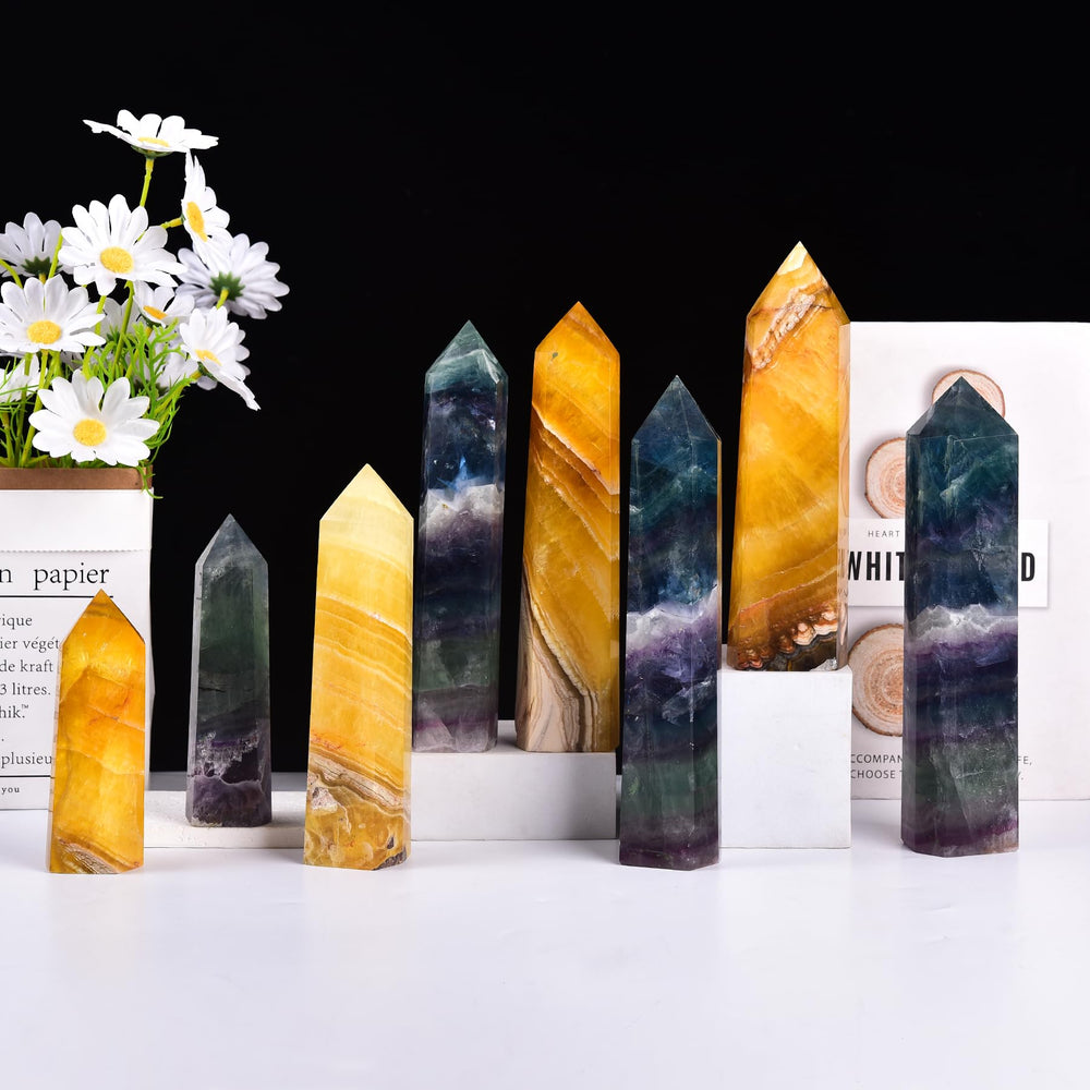 JIC Gem fluorite obelisk showcases radiant fluorescence in soft light.