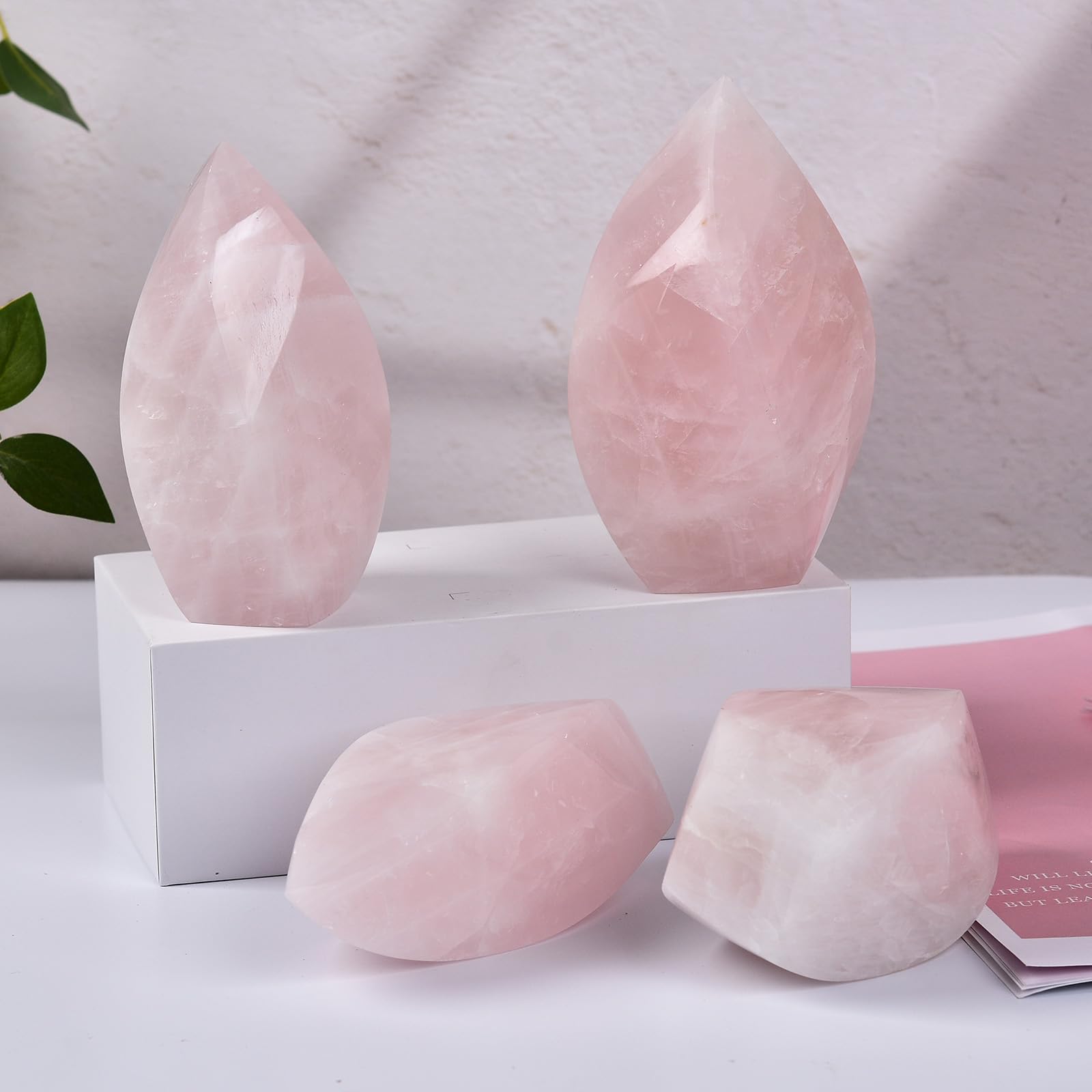 JIC Gem Rose Quartz Tower in bedroom decor, promotes soothing atmosphere.