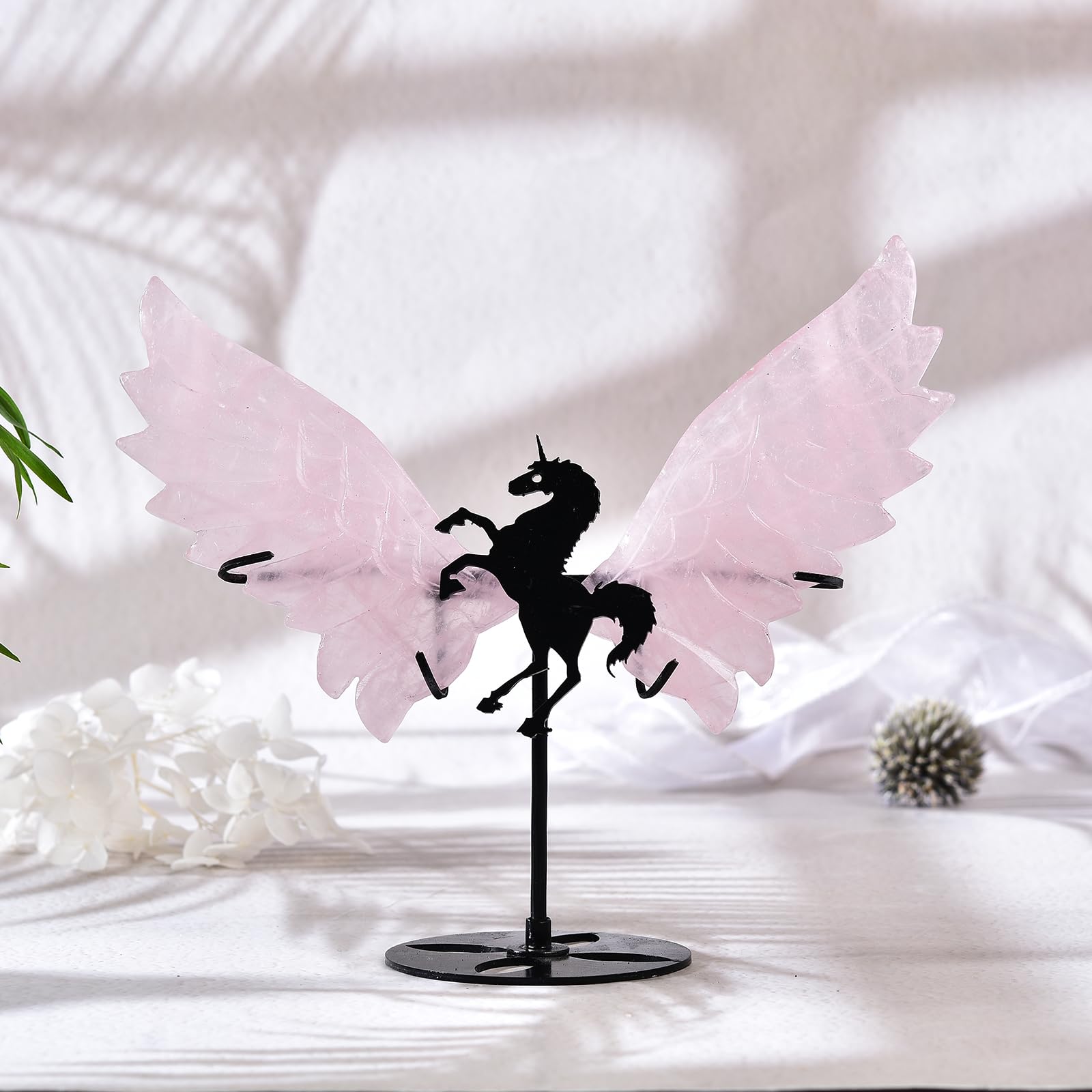 JIC Gem rose quartz wings pair with crystals for harmony in a shelf setup.