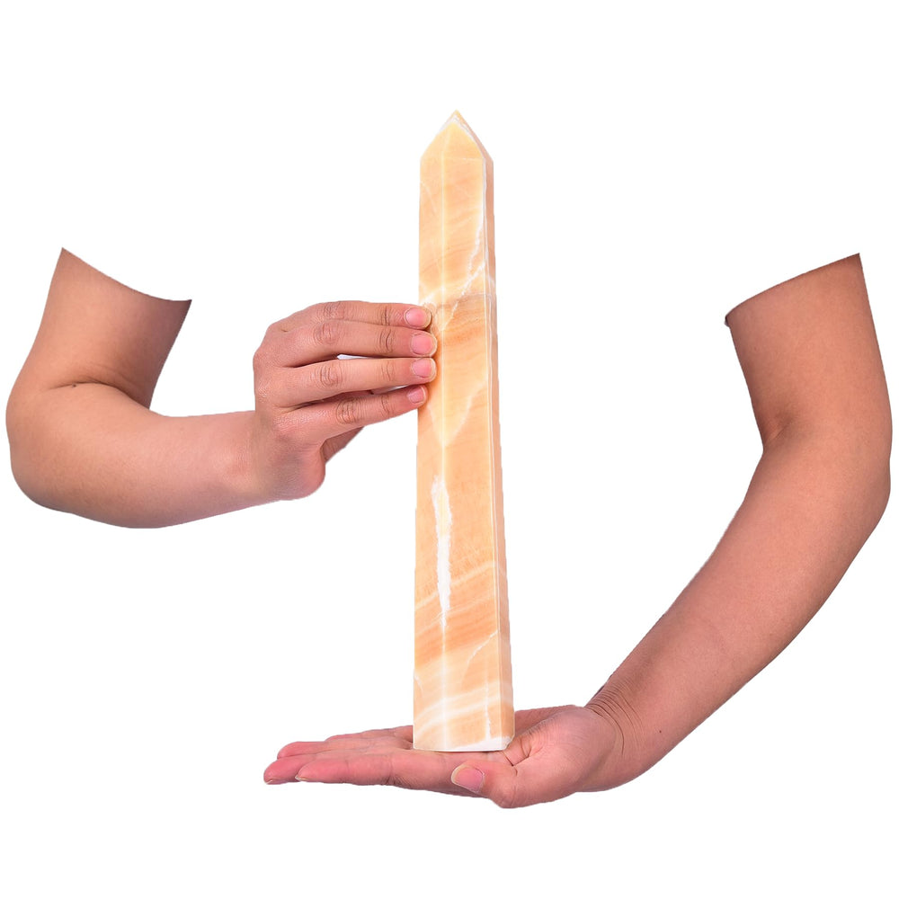 Close-up of JIC Gem yellow calcite wand showing natural facets.