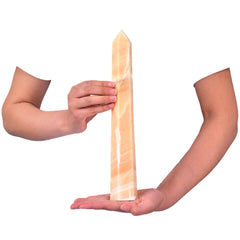 Close-up of JIC Gem yellow calcite wand showing natural facets.