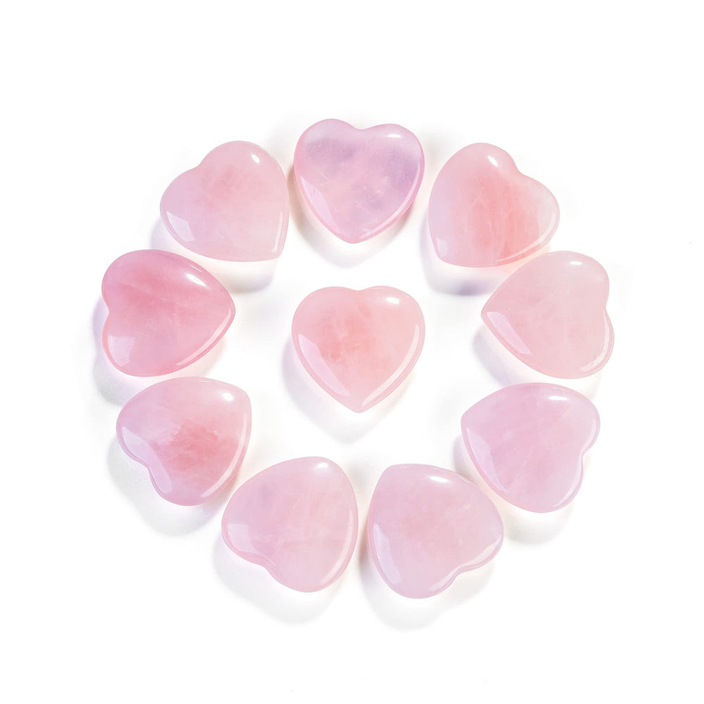Close-up of Jovivi rose quartz heart crystal showing natural marbling.