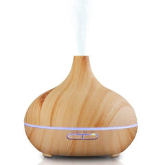 JoySusie diffuser with wood-grain brown front emits a subtle mist for cozy living spaces.