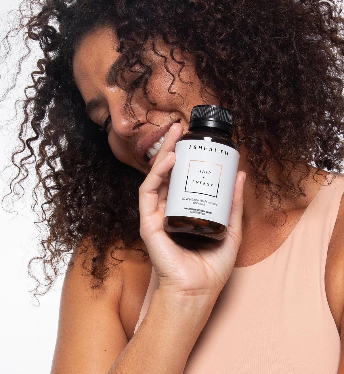 JSHealth Hair Formula with glass of water implies easy daily ingestion