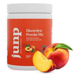 Glass of water with JUNP peach flavor for refreshing hydration