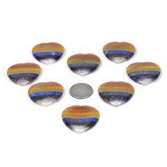 Justinstones hand-holding thumb stone demonstrates portable focus aid for mindfulness.