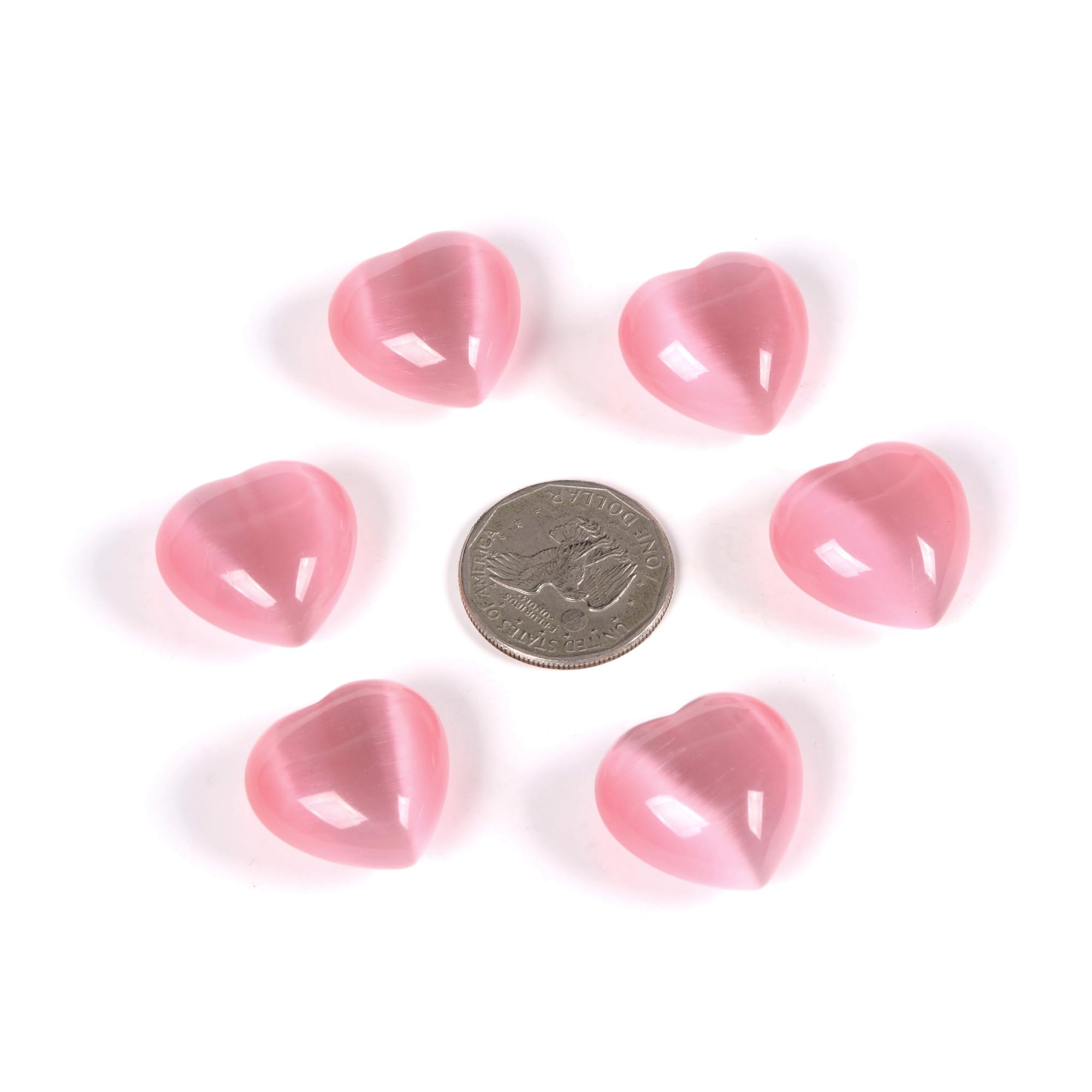 Justinstones pink cats-eye heart stones held in hand for gift-ready wellness decor.